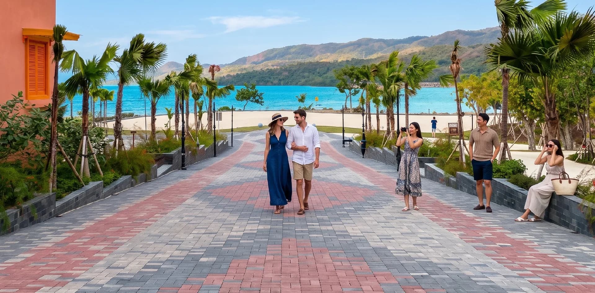 The paved, palm-lined Tenun Road walkway leading toward the sea