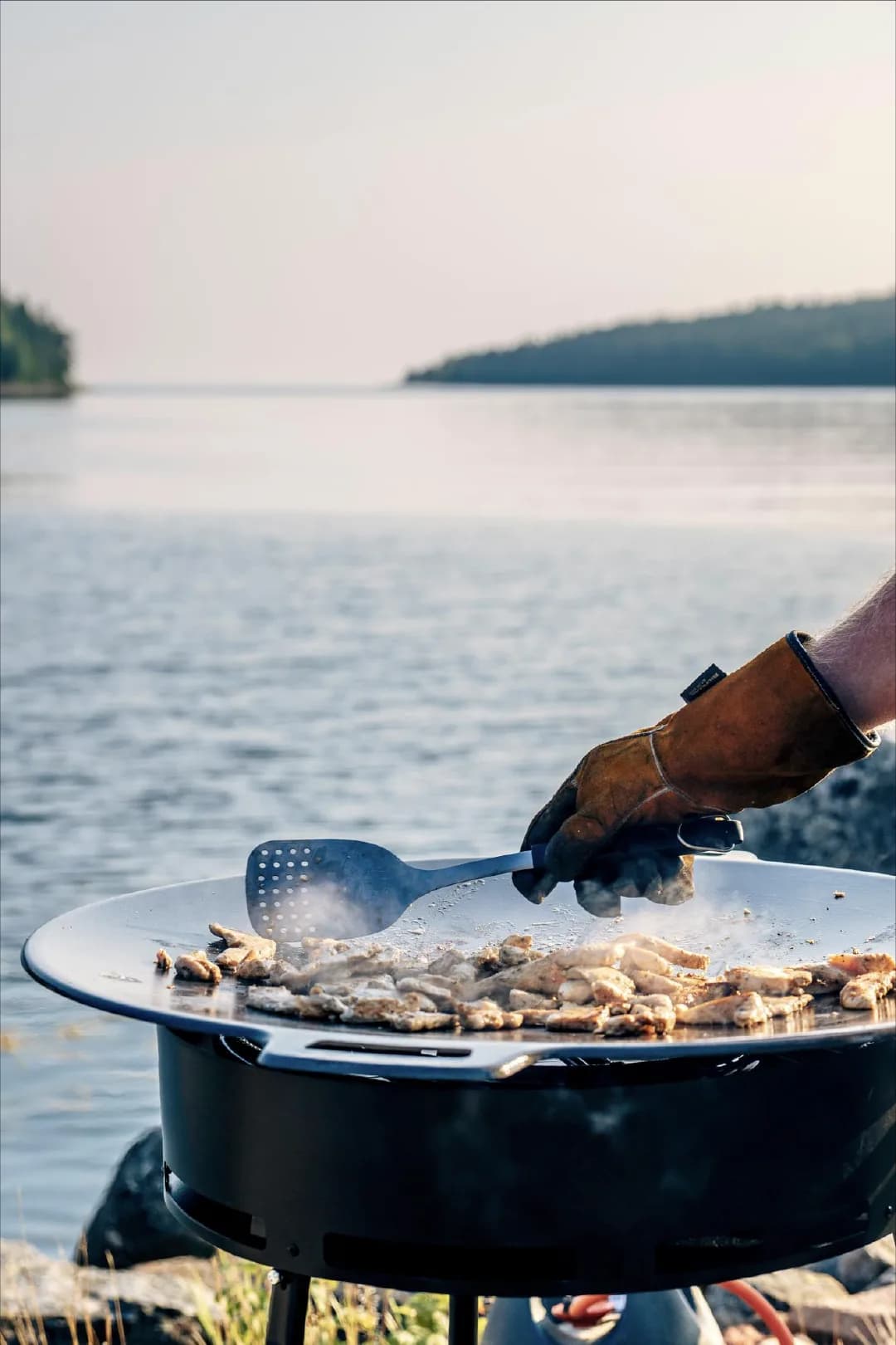 Chef cooking teppanyaki by the sea